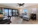 Comfortable living room featuring a workspace, sliding doors to a private balcony, and serene waterfront views at 6500 Flotilla Dr # 125, Holmes Beach, FL 34217