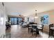 Open living space with dining area, ceiling fan, stylish decor, and beautiful water views from the window at 6500 Flotilla Dr # 125, Holmes Beach, FL 34217