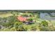 Aerial view of the community clubhouse surrounded by golf course and meticulously manicured grounds at 7334 Regina Royale # 74, Sarasota, FL 34238