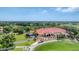 Overhead view of a clubhouse with verdant golf course, offering a vibrant community setting at 7334 Regina Royale # 74, Sarasota, FL 34238