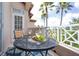 Balcony with a table, wine, and chairs for enjoying the view at 7334 Regina Royale # 74, Sarasota, FL 34238