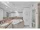 Bathroom featuring a soaking tub, granite countertops, white cabinets, and access to a separate toilet room at 7334 Regina Royale # 74, Sarasota, FL 34238
