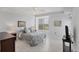 Cozy bedroom featuring tile floors, a comfortable bed, and bright natural lighting at 7334 Regina Royale # 74, Sarasota, FL 34238