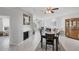 Open-concept dining area with tile flooring, fireplace and views of the living room at 7334 Regina Royale # 74, Sarasota, FL 34238
