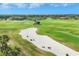 Overhead view of meticulously maintained golf course with vibrant green fairways and a pristine sand trap at 7334 Regina Royale # 74, Sarasota, FL 34238