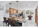 Bright kitchen featuring a breakfast bar with granite countertops and wooden cabinets at 7334 Regina Royale # 74, Sarasota, FL 34238