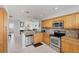 A well-lit kitchen features stainless steel appliances, granite counters, and light wood cabinets at 7334 Regina Royale # 74, Sarasota, FL 34238