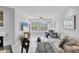 Bright and airy living room with beach view from expansive windows at 7334 Regina Royale # 74, Sarasota, FL 34238