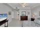 Bright main bedroom featuring tile floors, ceiling fan, and access to the ensuite bathroom and hallway at 7334 Regina Royale # 74, Sarasota, FL 34238