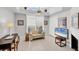 Bright office with a vaulted ceiling, modern furniture, and a cozy seating area at 7334 Regina Royale # 74, Sarasota, FL 34238