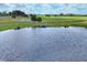 Aerial view capturing the tranquil pond on the golf course, complete with lush landscaping and local wildlife at 7334 Regina Royale # 74, Sarasota, FL 34238