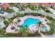 Community pool surrounded by lush greenery and palm trees, offering a resort-like experience at 7334 Regina Royale # 74, Sarasota, FL 34238