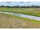 Close aerial shot of a water feature and lush green fairways of the community golf course at 7334 Regina Royale # 74, Sarasota, FL 34238