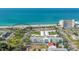 Aerial view of beachfront condos with manicured lawns, beach access, and scenic ocean views at 755 Taplow Rd, Venice, FL 34293