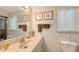 Bright bathroom featuring a vanity with a sink, decorative mirrors, and essential toiletries at 755 Taplow Rd, Venice, FL 34293
