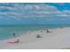 Sunny beach scene with people relaxing, offering a picturesque coastal lifestyle for residents at 755 Taplow Rd, Venice, FL 34293