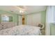 Well-lit bedroom features soft green walls, closet, and a cozy chair at 755 Taplow Rd, Venice, FL 34293
