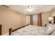 Well-lit bedroom boasts a ceiling fan, window with curtains, and a pleasant ambiance at 755 Taplow Rd, Venice, FL 34293