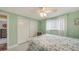 Bright bedroom featuring green walls, closet, and a comfortable bed at 755 Taplow Rd, Venice, FL 34293