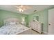 Comfortable bedroom featuring green walls, and a dresser with mirror at 755 Taplow Rd, Venice, FL 34293