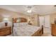 Cozy bedroom featuring ceiling fan, beach-themed decor, and natural light at 755 Taplow Rd, Venice, FL 34293