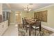 Open dining area featuring chandelier, dining table for six with view into kitchen at 755 Taplow Rd, Venice, FL 34293