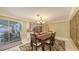 Dining room with patio access, chandelier, and seating for six, bright natural lighting at 755 Taplow Rd, Venice, FL 34293