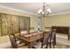 Formal dining room features a wood table with seating for six and elegant chandelier at 755 Taplow Rd, Venice, FL 34293