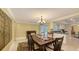 Bright dining room with chandelier and decorative artwork, adjacent to the kitchen at 755 Taplow Rd, Venice, FL 34293