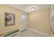 Inviting entryway with a tiled floor, artwork, and a charming bench, leading to a bright home interior at 755 Taplow Rd, Venice, FL 34293