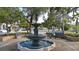 Ornate tiered fountain surrounded by lush greenery, providing a peaceful park setting for residents at 755 Taplow Rd, Venice, FL 34293