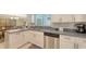 Bright kitchen featuring stainless steel appliances, white cabinetry, and modern countertops at 755 Taplow Rd, Venice, FL 34293