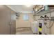 Functional laundry room with washer, dryer, storage shelves and water heater at 755 Taplow Rd, Venice, FL 34293