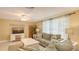 Comfortable living room with tile floors, ceiling fan, a television, and cozy seating, perfect for relaxation at 755 Taplow Rd, Venice, FL 34293