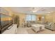 Bright living room featuring tile floors, neutral decor, comfortable seating, and natural light at 755 Taplow Rd, Venice, FL 34293
