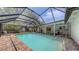 Screened pool area featuring a spacious pool, brick pavers and a patio area at 755 Taplow Rd, Venice, FL 34293