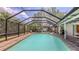 Screened pool area featuring a spacious pool, brick pavers and a patio area at 755 Taplow Rd, Venice, FL 34293