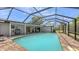 Screened pool area featuring a spacious pool, brick pavers and patio with outdoor grill at 755 Taplow Rd, Venice, FL 34293