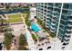 High-rise building with a rooftop pool, palm trees, sunbathing cabanas, and ample seating with city views at 777 N Ashley Dr # 1712, Tampa, FL 33602