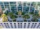 Aerial view of a high-rise building featuring a landscaped entrance, palm trees, and a modern design at 777 N Ashley Dr # 1712, Tampa, FL 33602