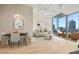 Bright open-plan living room with dining area and floor-to-ceiling windows showcasing city views at 777 N Ashley Dr # 1712, Tampa, FL 33602