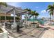 Outdoor kitchen with pergola cover, built-in grill, dining table and chairs, and lounge chairs by the pool at 777 N Ashley Dr # 1712, Tampa, FL 33602