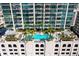 Aerial view of an outdoor pool surrounded by palm trees and lounge chairs on a sunny day at 777 N Ashley Dr # 1712, Tampa, FL 33602