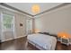 Inviting bedroom featuring tray ceiling, hardwood floors, and natural light at 867 Bacon Ave, Sarasota, FL 34232