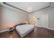 Bright bedroom featuring tray ceiling, hardwood floors and ensuite bathroom access at 867 Bacon Ave, Sarasota, FL 34232