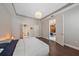 Spacious bedroom featuring tray ceiling, hardwood floors and multiple access doors at 867 Bacon Ave, Sarasota, FL 34232