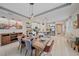 Bright dining room open to kitchen with a rustic wood table and modern decor at 867 Bacon Ave, Sarasota, FL 34232