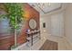 Inviting foyer with wood accent wall, modern shelving, and stylish decor at 867 Bacon Ave, Sarasota, FL 34232