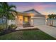 Beautiful dusk view of a single-story home with inviting entrance and landscaped yard at 867 Bacon Ave, Sarasota, FL 34232
