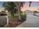 Charming single-story home with a well-manicured lawn, mature trees, and a long driveway leading to a two-car garage at 867 Bacon Ave, Sarasota, FL 34232